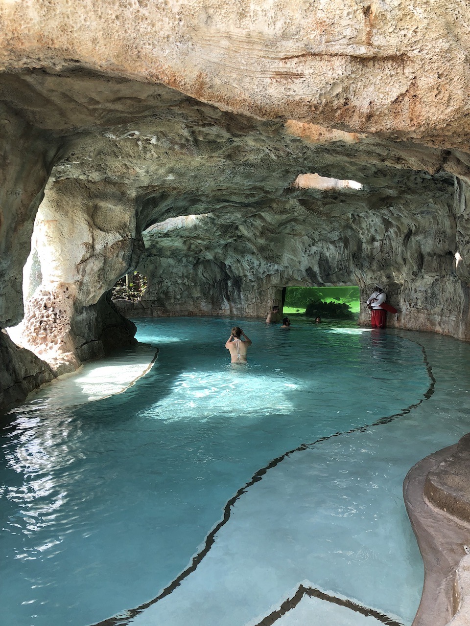 Grotto with aquarium view of nurse sharks and rays