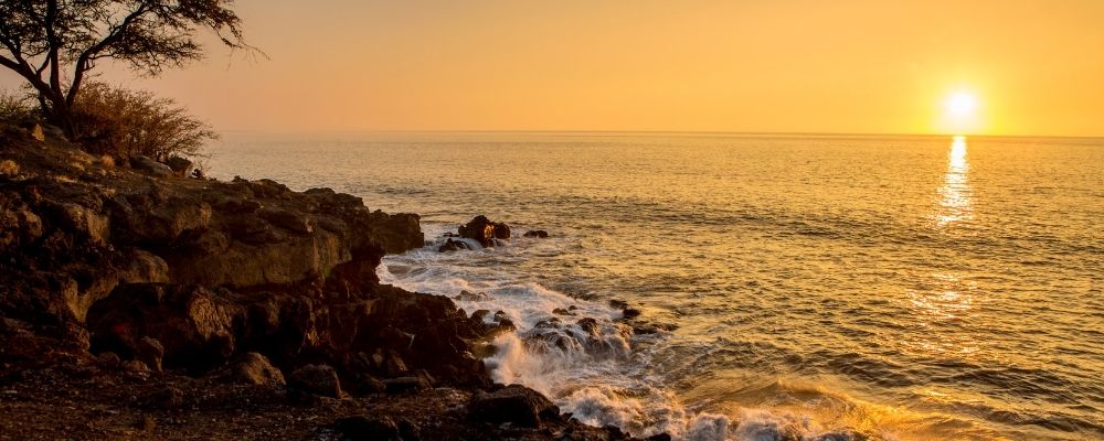 Sunset off Kohala Coast for best luau in Big Island