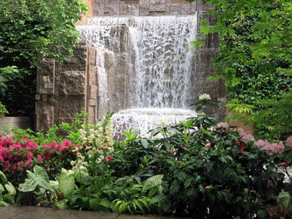 waterfall scene with fllowers are giving a view