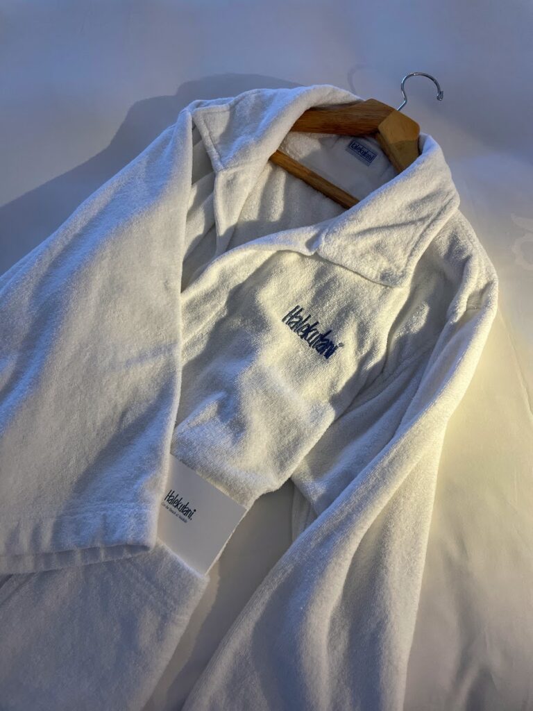 One of the Halekulani hotel robes laying on a bed