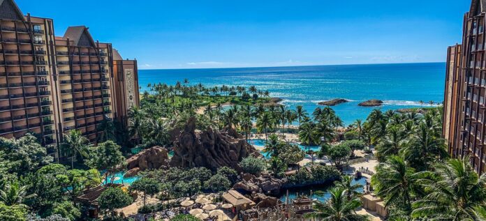 a beach with palm trees and a body of water