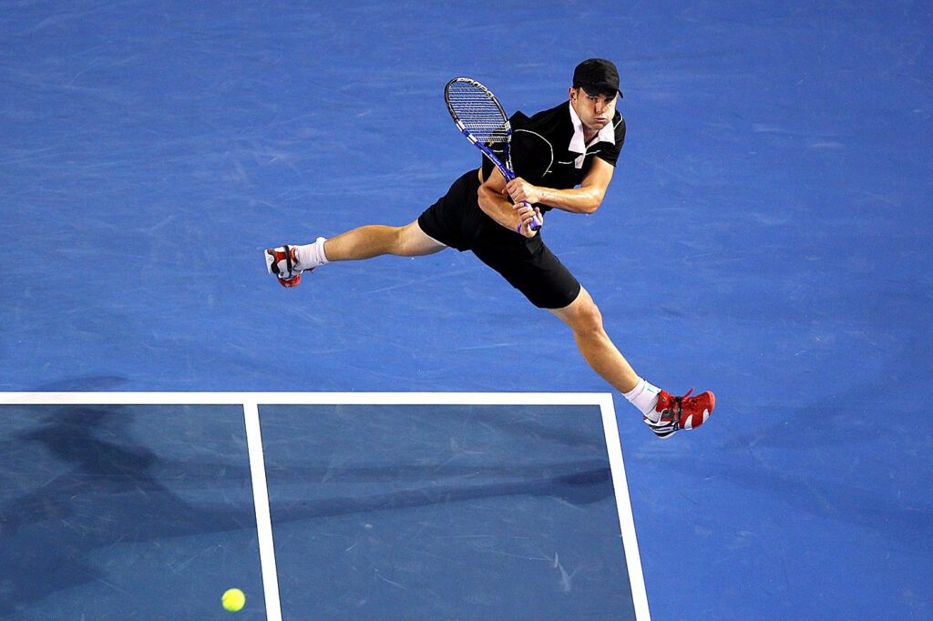 Andy Roddick hitting a tennis ball for one of the Marriott Bonvoy Moments