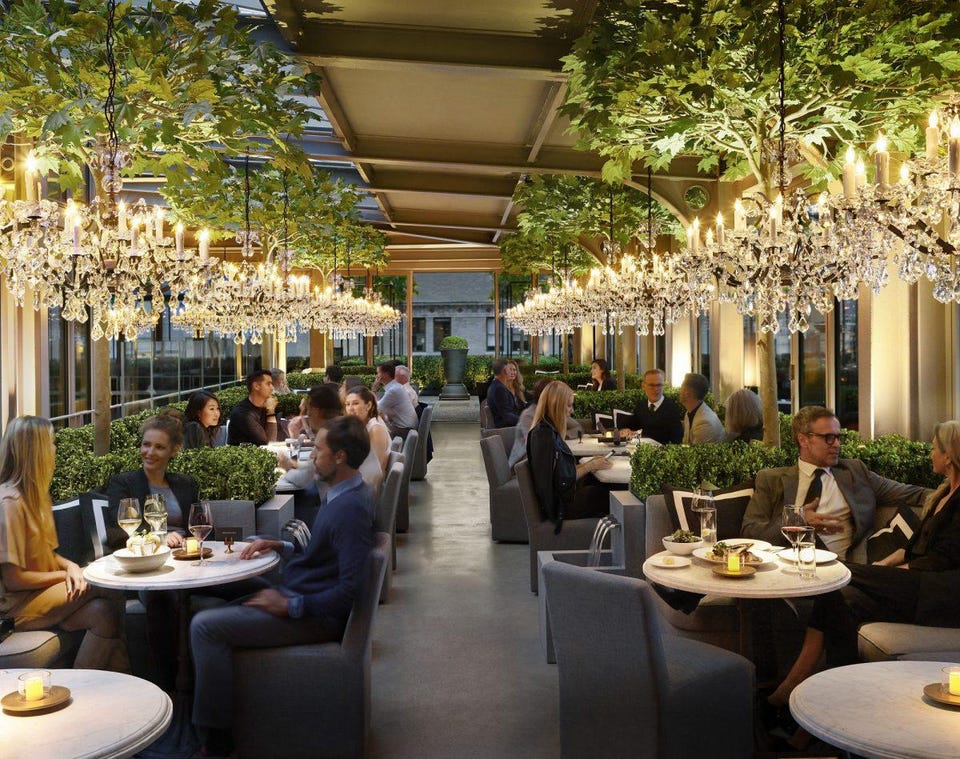 a beautiful scene of a hotel where people are sitting in a rows