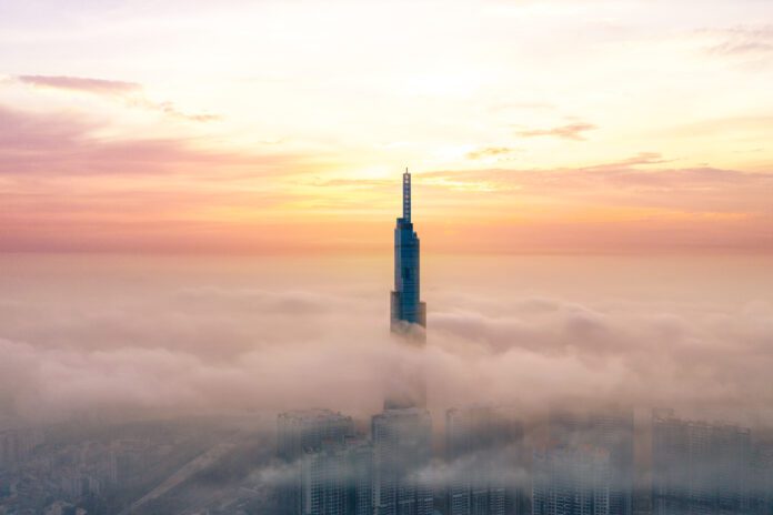 a tall building in the clouds