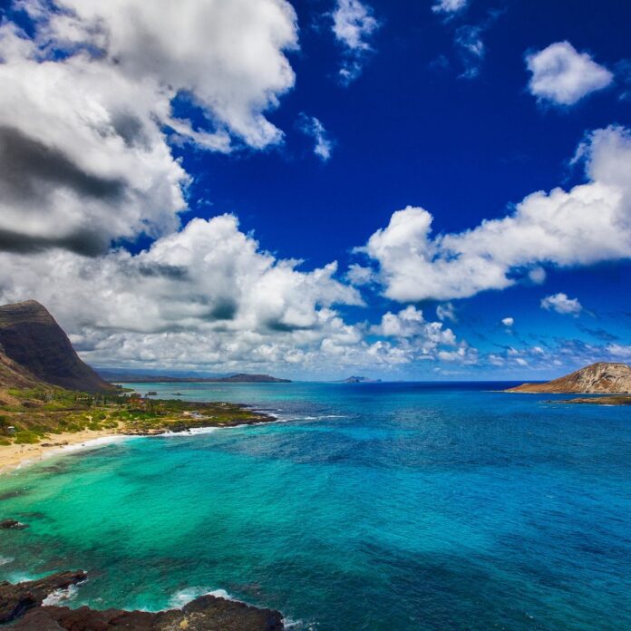 a beach with a sandy beach and mountains