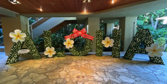 a large sign with flowers and lights