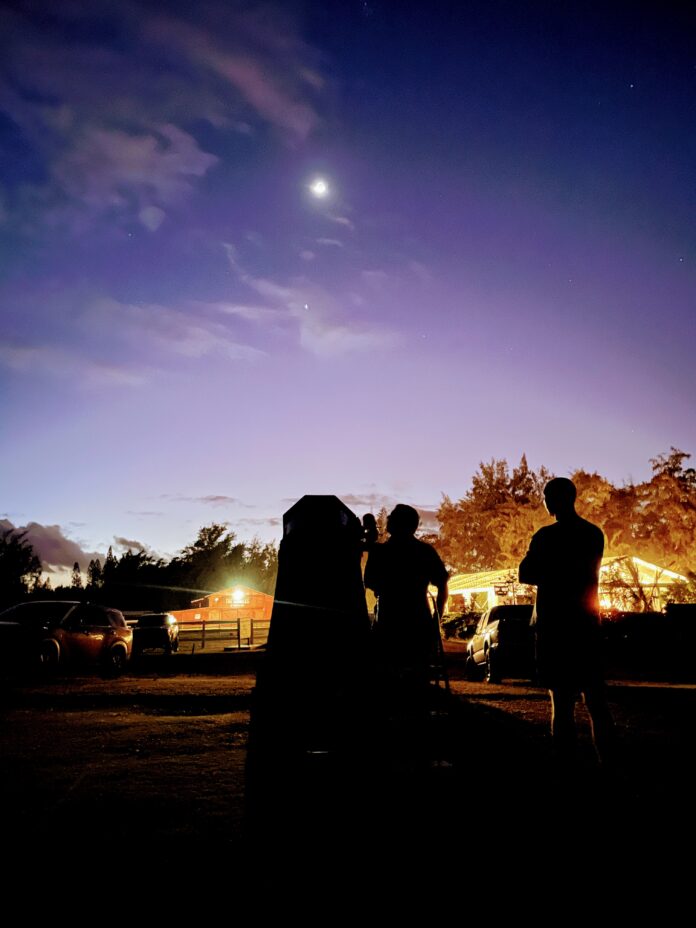 a group of people standing in a yard