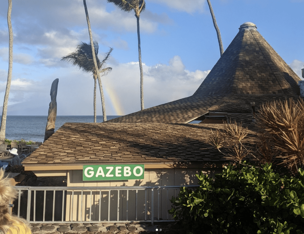 a building with a triangular roof and a sign on it