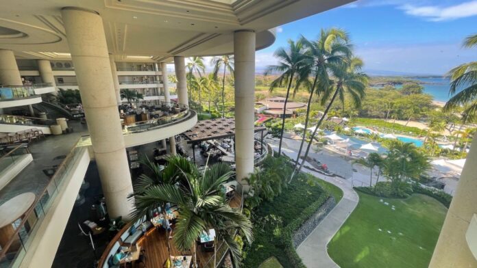 a building with palm trees and a pool
