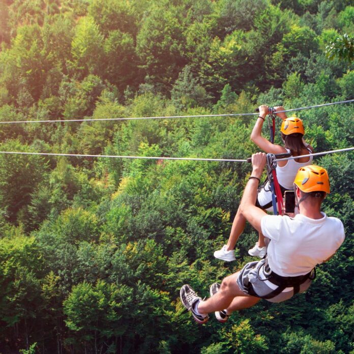 a man and woman in a zip line
