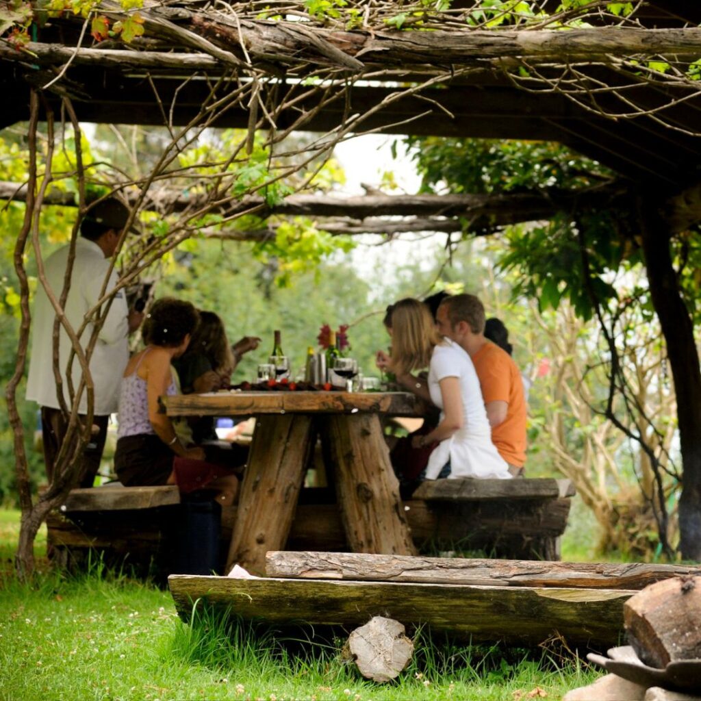 a group of people sitting at a picnic table