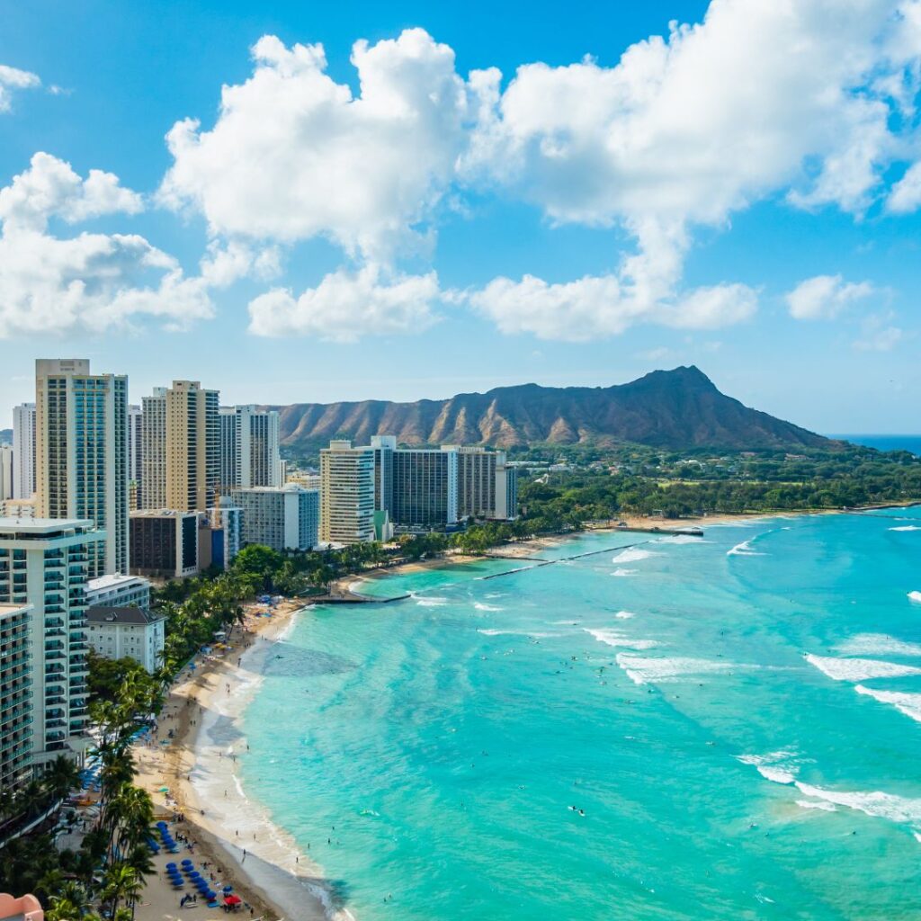 a beach with buildings and a body of water