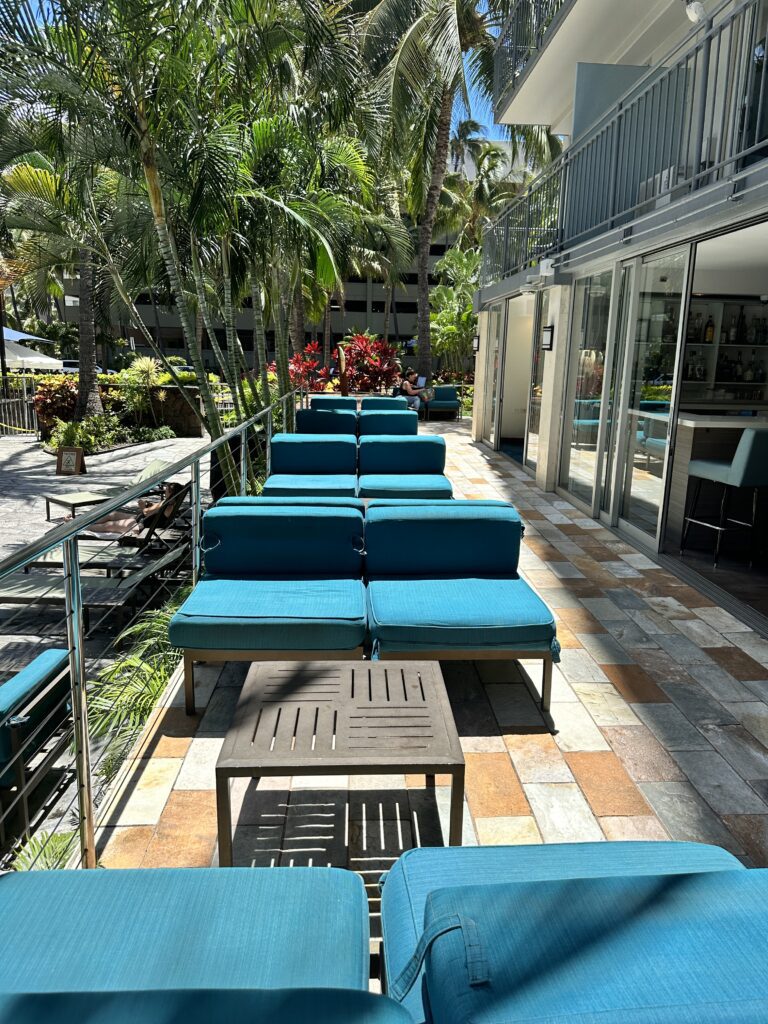 a patio with blue chairs and tables