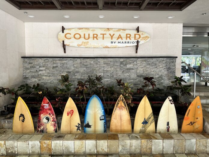 a row of surfboards in front of a building