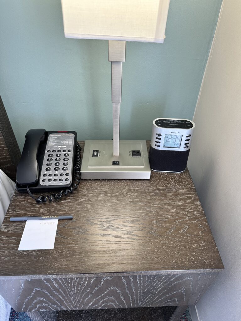 a desk with a telephone and a phone on it