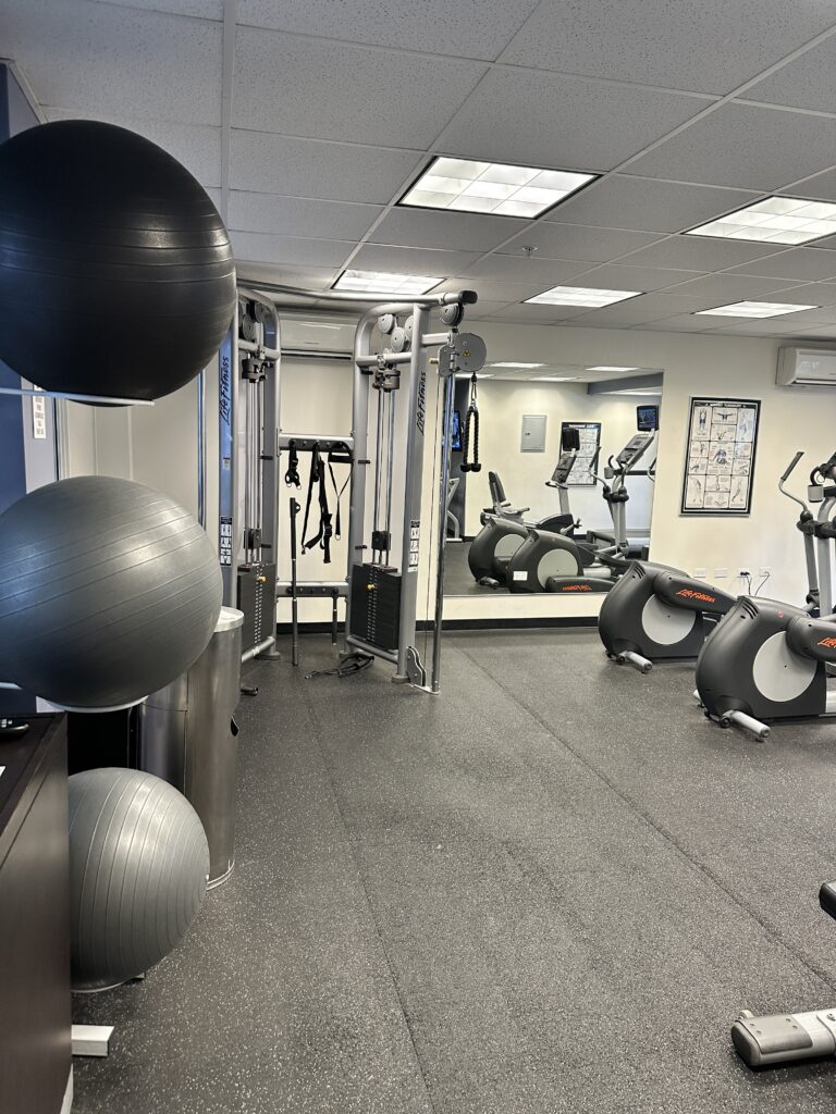 a room with exercise equipment and exercise balls