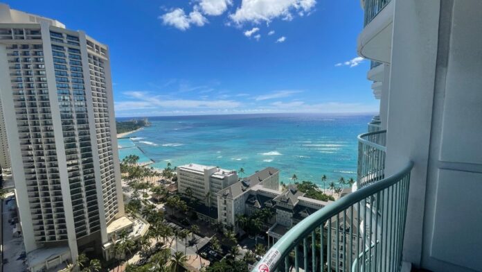 a view of a beach and buildings from a balcony