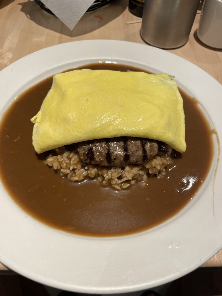 a plate of food with a piece of meat and rice