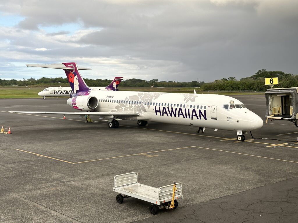 a white airplane on the tarmac hawaiian airlines hilo to honolulu