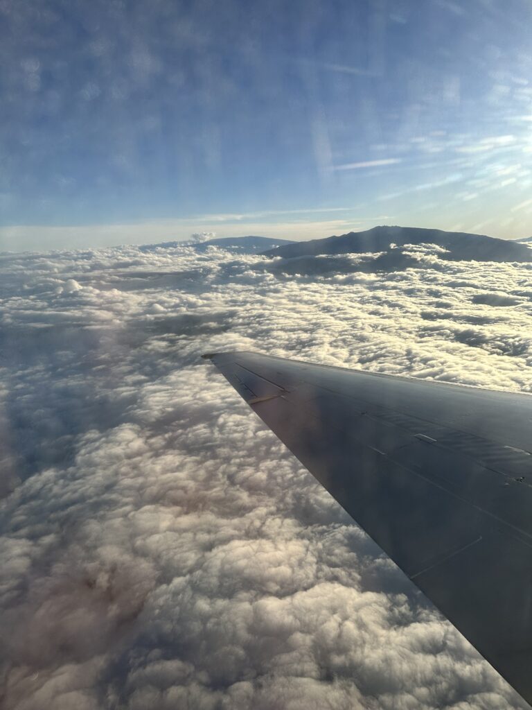 an airplane wing above the clouds