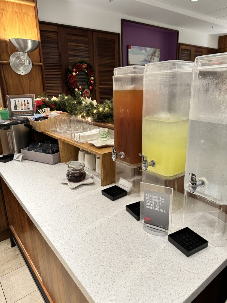a row of drinks dispensers on a counter