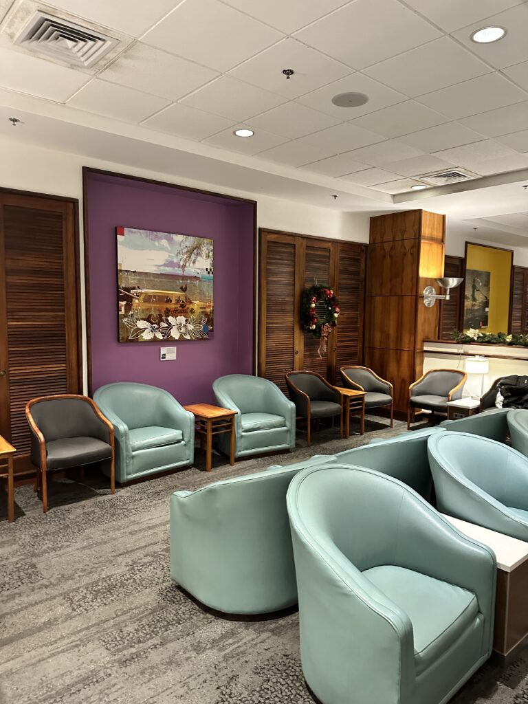 a room with chairs and a purple wall