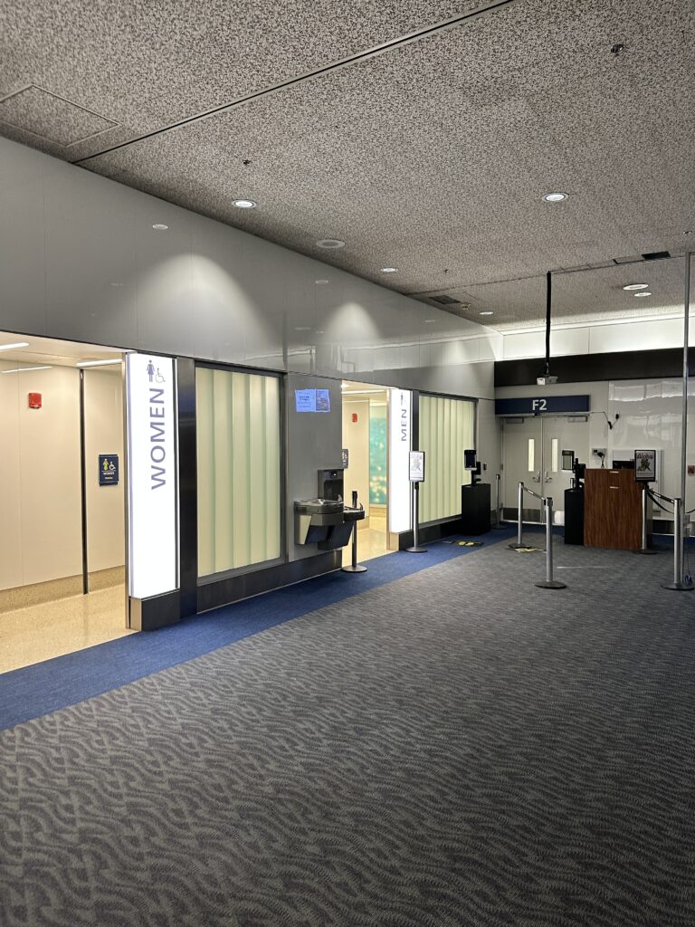 a building with a glass wall and a door near gate F2 at the Honolulu Airport