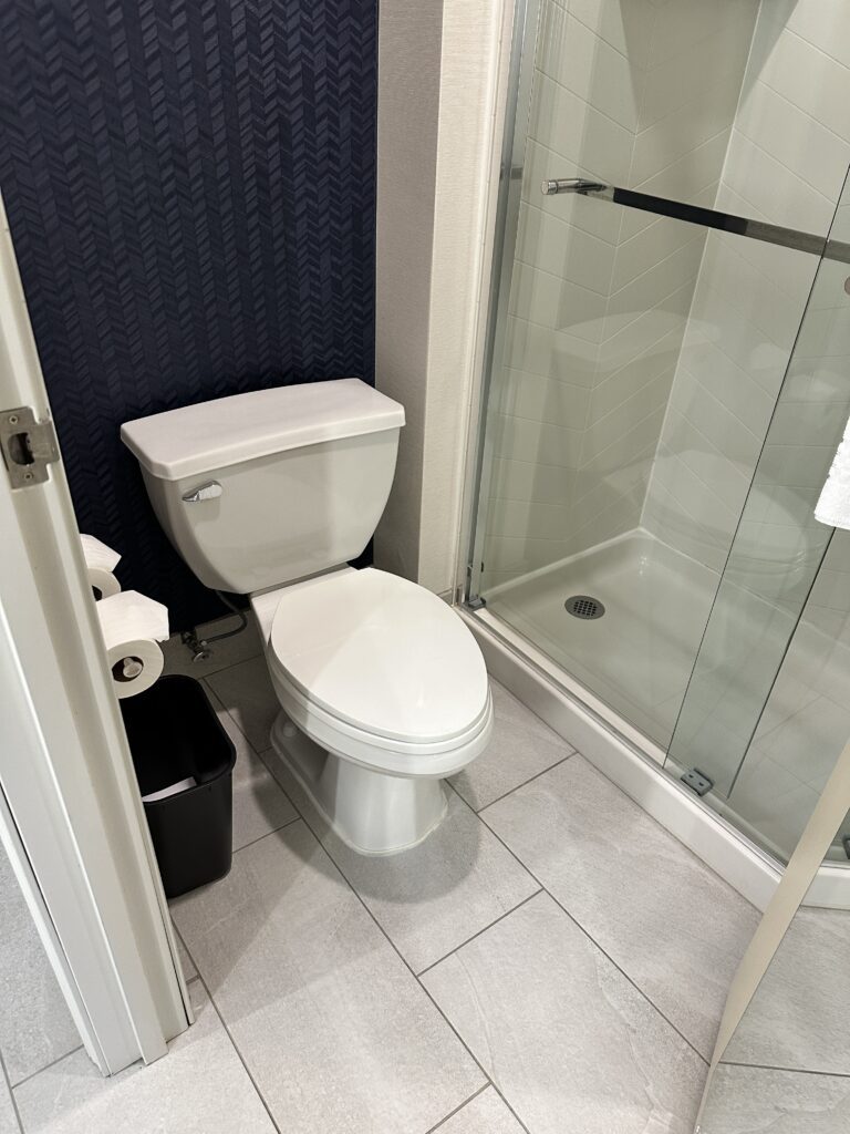 a bathroom with a glass shower door