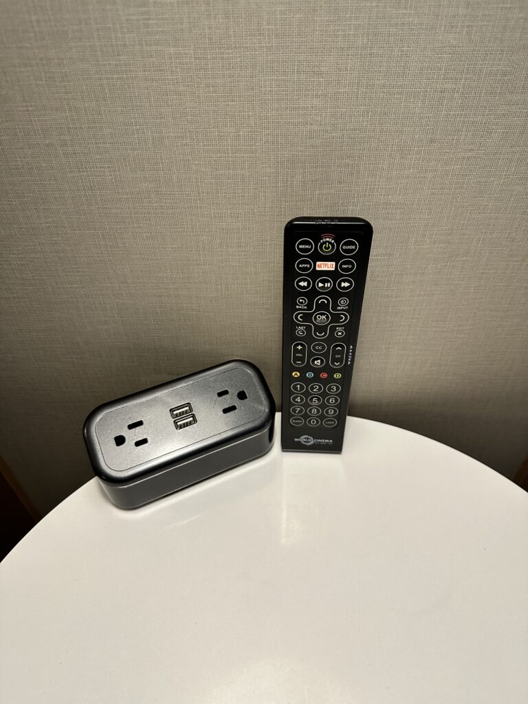 a remote control and power outlet on a table