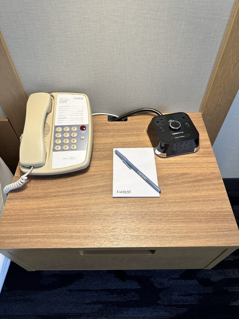 a telephone and a pen on a table