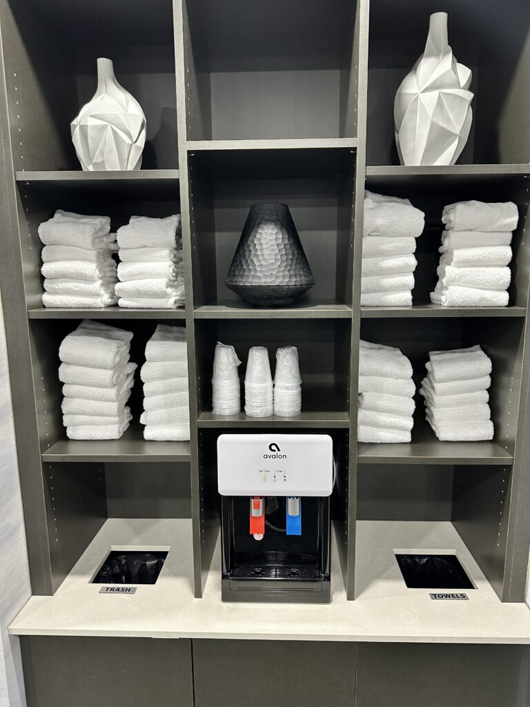 a shelf with towels and vases on it