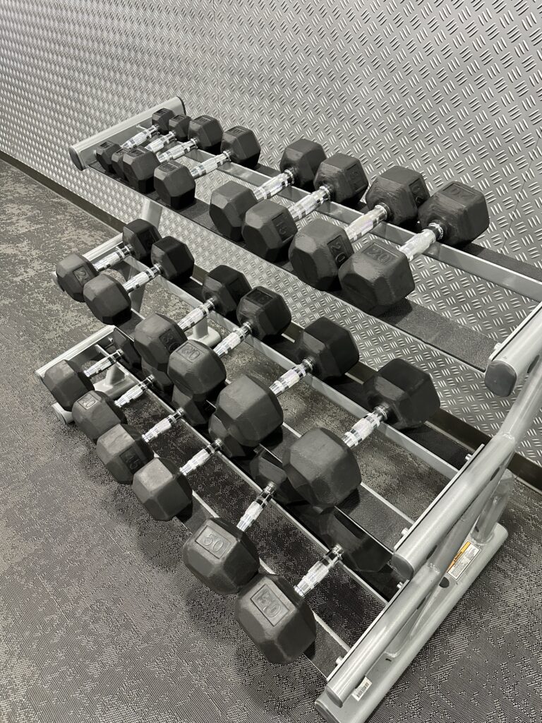 a rack of dumbbells on a floor