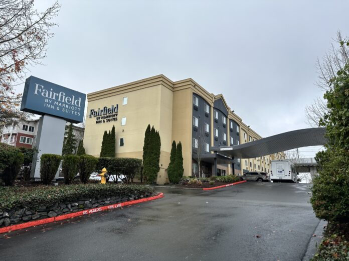 a building with a sign and a parking lot