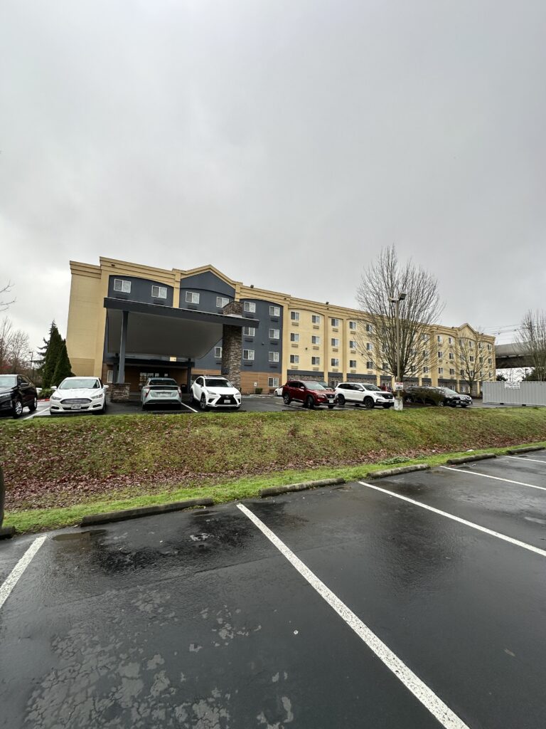 a parking lot with cars parked in front of a building