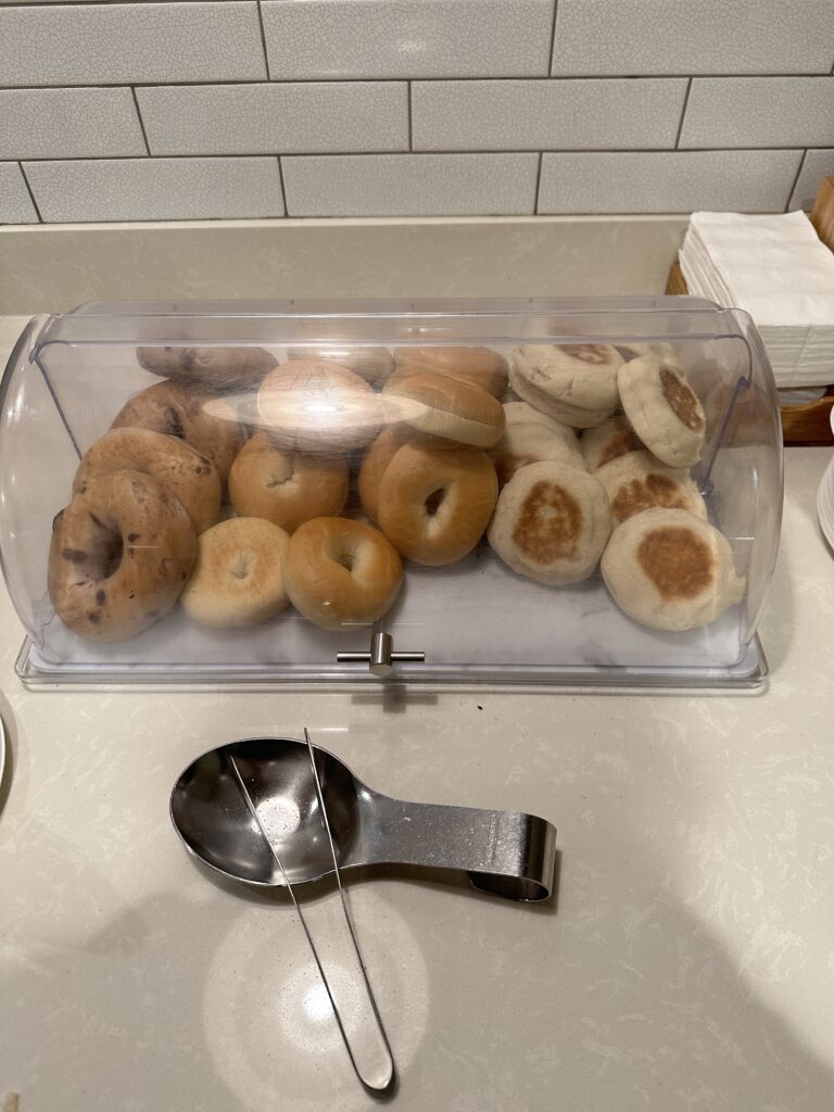 a tray of bagels and a spoon