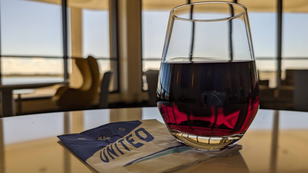 a glass of red liquid on a napkin