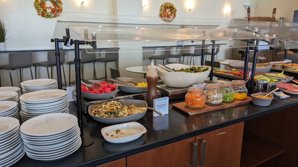 a buffet with plates and bowls of food