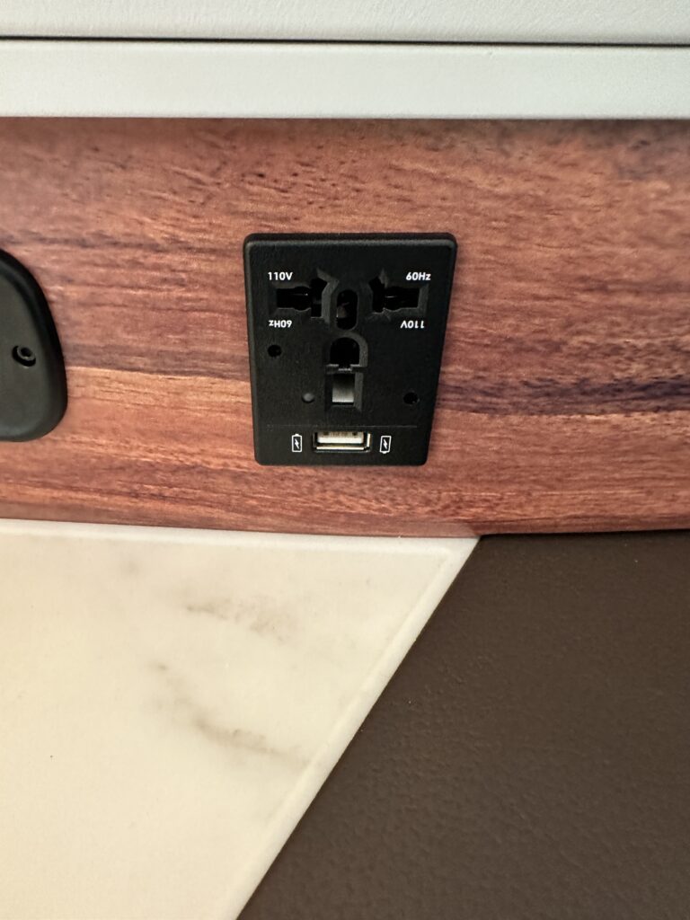 a black outlet on a wood surface