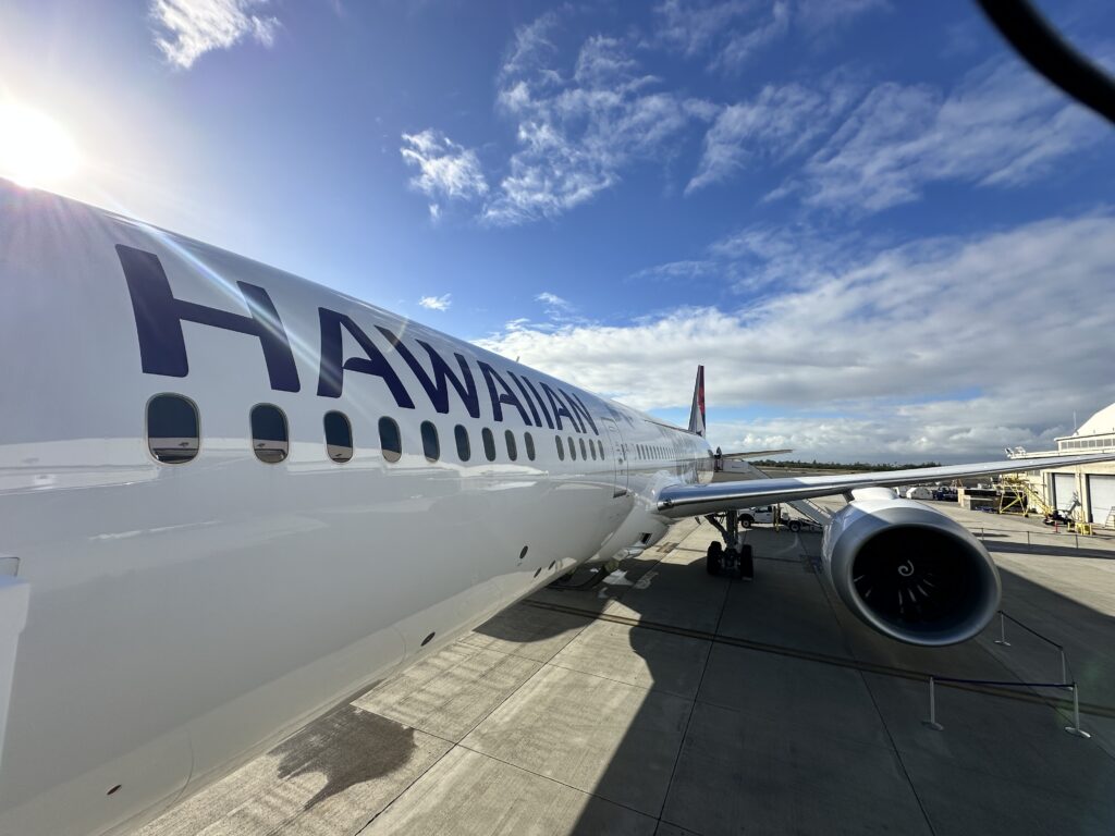 a large white airplane with blue writing on it