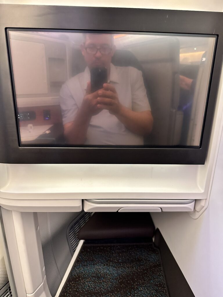 a man taking a selfie in an airplane