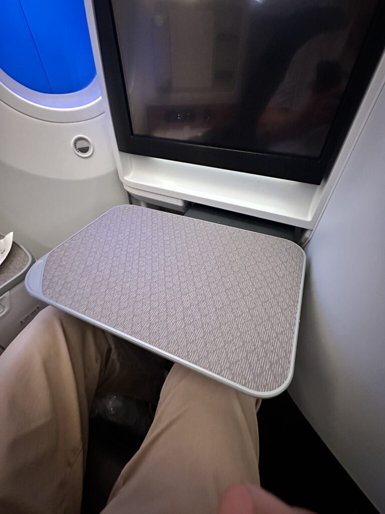 a person sitting on a chair with a table on their head