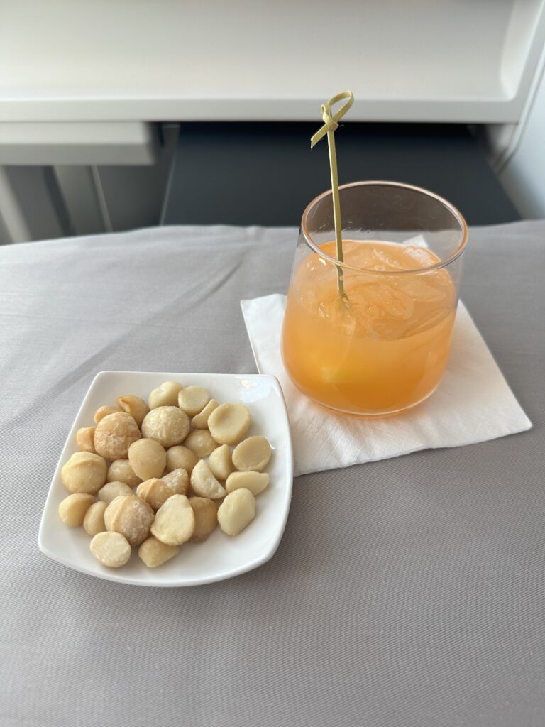 a plate of food and a drink on a napkin