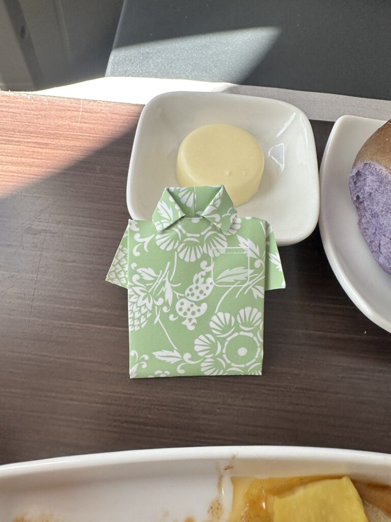 a plate of food and a green shirt on a table